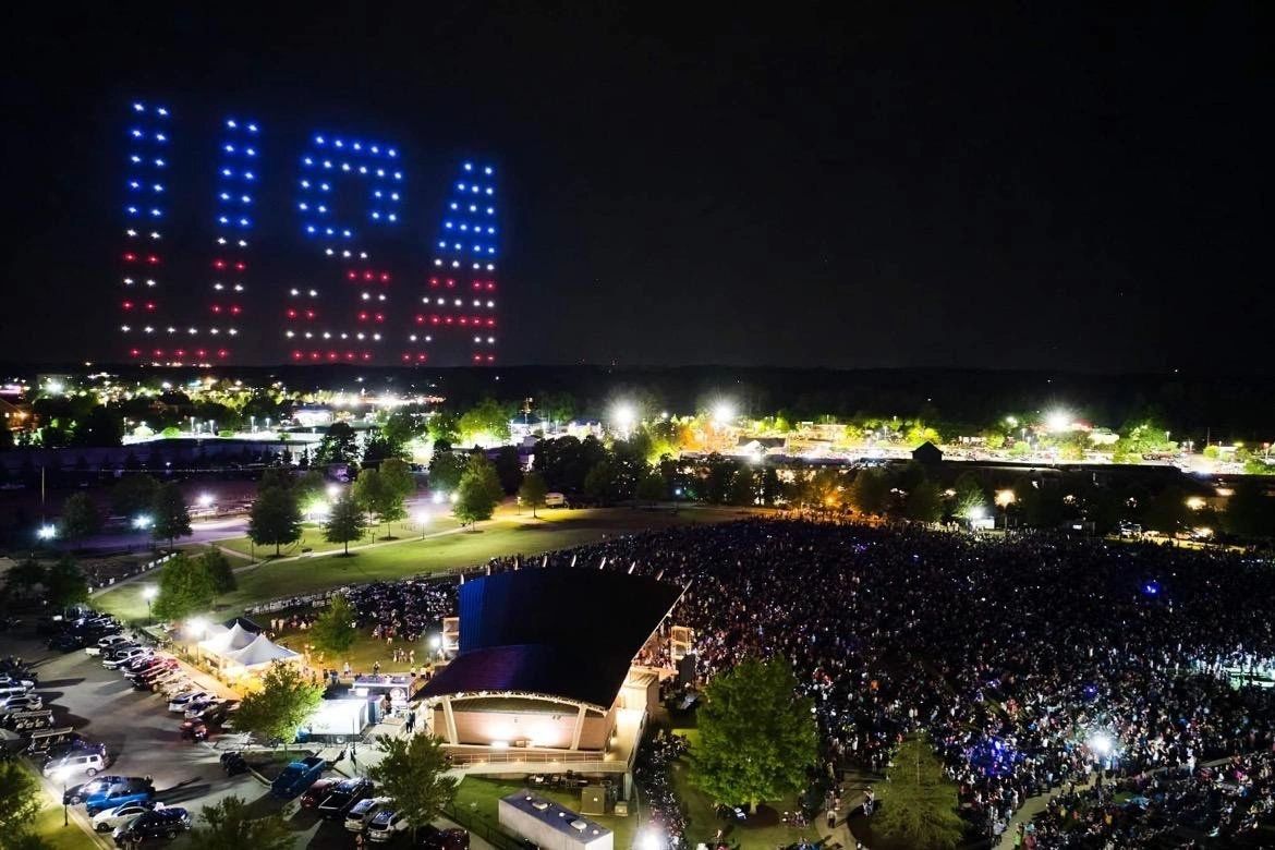 Drones spelling USA above an outdoor event